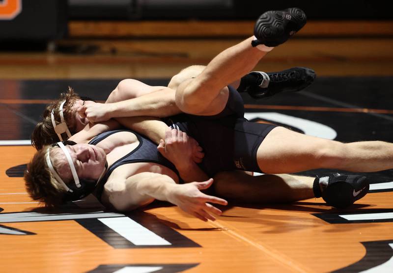 DeKalb’s Michael Hodge tries to score points against Cole Kleiser Friday, Jan. 17, 2025, during their 150 pound match at DeKalb High School.