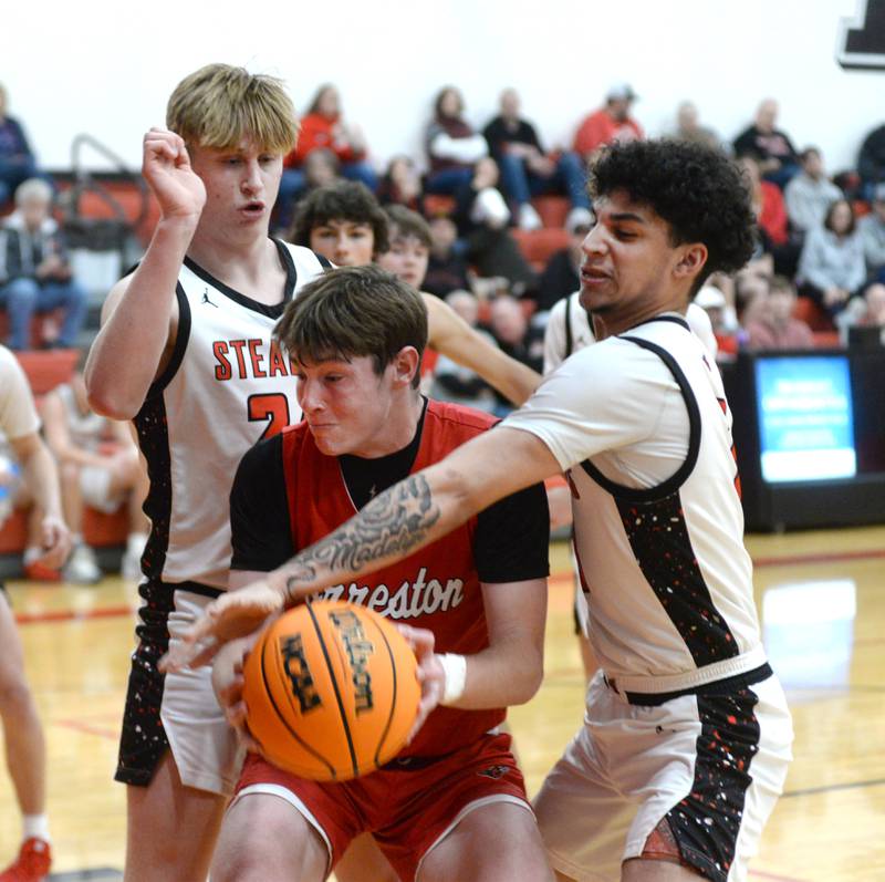 Fulton's Jace Bielenberg (3) and Jacob Huisenga (24) try and trap Forreston's Brendan Greenfield (0) during Friday, Dec. 27, 2024 action at the Cliff Warkins Memorial Basketball Tournament at Erie High School.