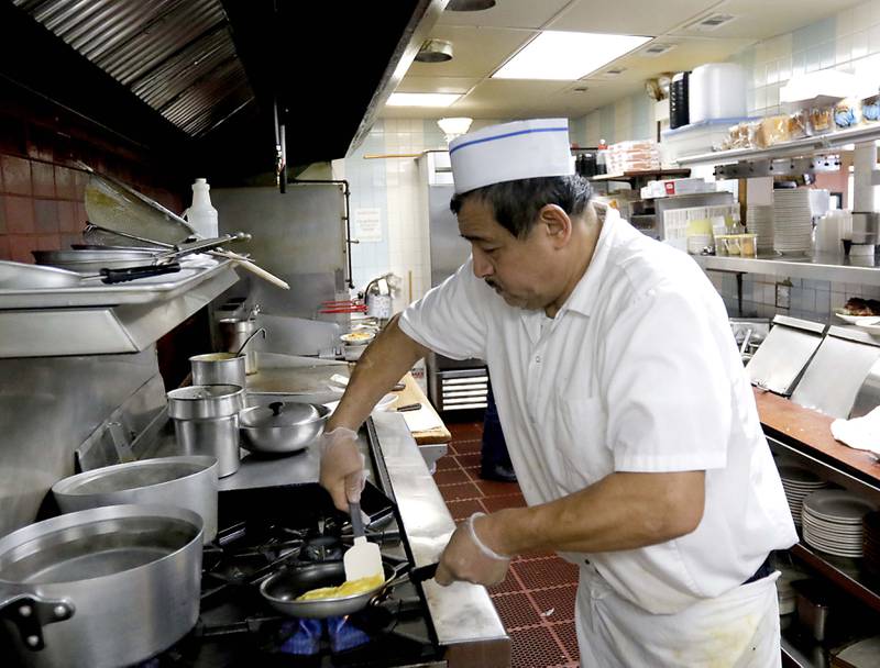 Tony Loera makes an order of scrambled eggs on Friday, March 21, 2025, at Andy's Restaurant, in Crystal Lake.