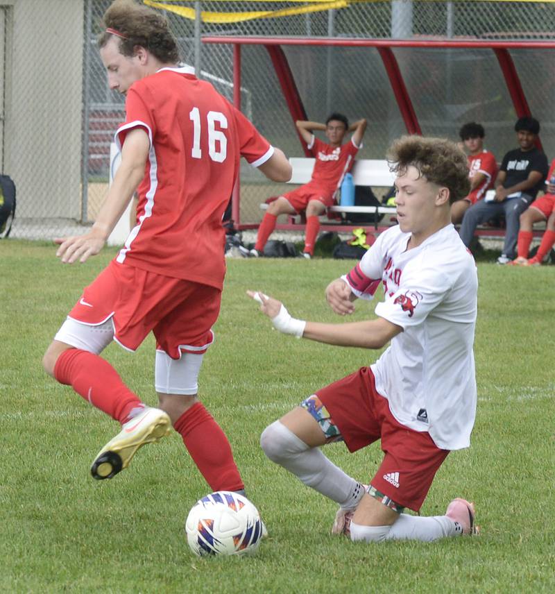 Streator’s Issac Fowler falls as he and Ottawa’s Ian Fulkerson give chase to the ball in the 1st half of Saturday’s match at Ottawa.