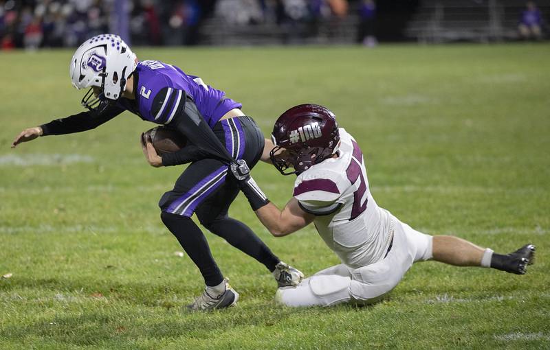 Dixon’s Cullen Shaner is hauled down by Marengo’s Connor Sacco Friday, Nov. 1, 2024 in the 4A football playoffs in Dixon.