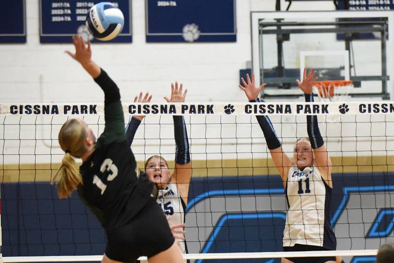 Cissna Park's Sophie Duis, right, and Ava Henrichs, center, look to block a hit from Bishop McNamara's Emma Thyfault during a game at Cissna Park Wednesday, Oct. 15, 2025.