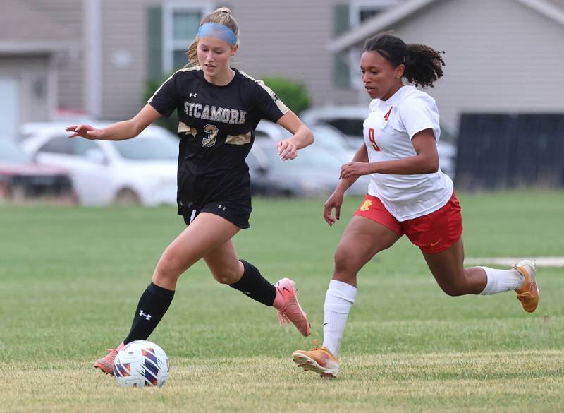 Sycamore's Marin Gautcher pushes the ball ahead of Rock Island's Aubrey Doss Friday, May 22, 2026, during their Class 2A regional championship matchup at Sycamore High School.