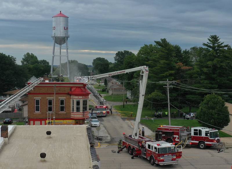 Firefighters work the scene of a structure fire at 201 North Main Street on Monday, Aug. 14, 2023 at Ladd. The fire happened just before 7:30a.m. and was upgraded to a three-alarm fire.  Firefighters from Mendota, Ladd, Peru, La Salle, Utica, Princeton and others helped with the blaze.
