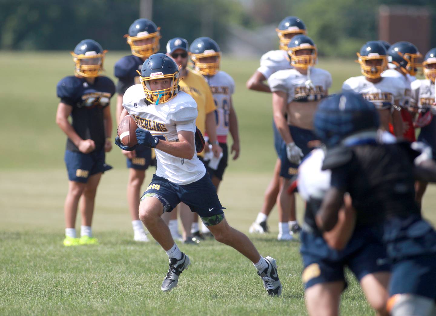 Sterling’s Cobey Shipma runs the ball during a joint practice with Glenbard South and Oswego East football teams on Tuesday, July 15, 2025 in Oswego.