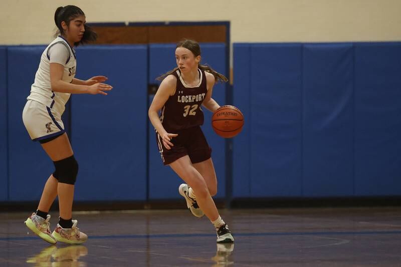 Lockport’s Lucy Hynes rolls out after a rebound against Joliet Central.