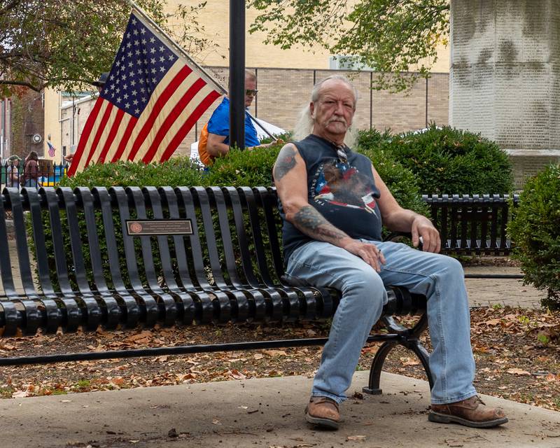 Man sits on bench at the ‘No Kings 2.0’ Protest on Saturday, October 18, 2025 at Washington Square Park in Ottawa.