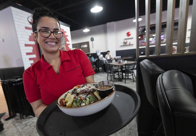 Ariana Diaz displays a gourmet salad Thursday, March 19, 2026, at Artisan Oven in Sterling.