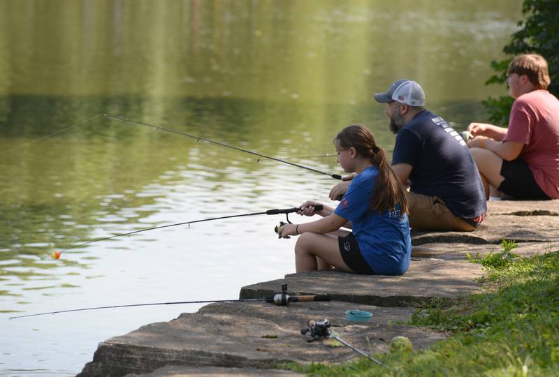 Ella, Jeff and Anthony Bertaccha of Downers Grove participate in the annual Fishing Derby held at Patriots Park Saturday Aug 6, 2022.