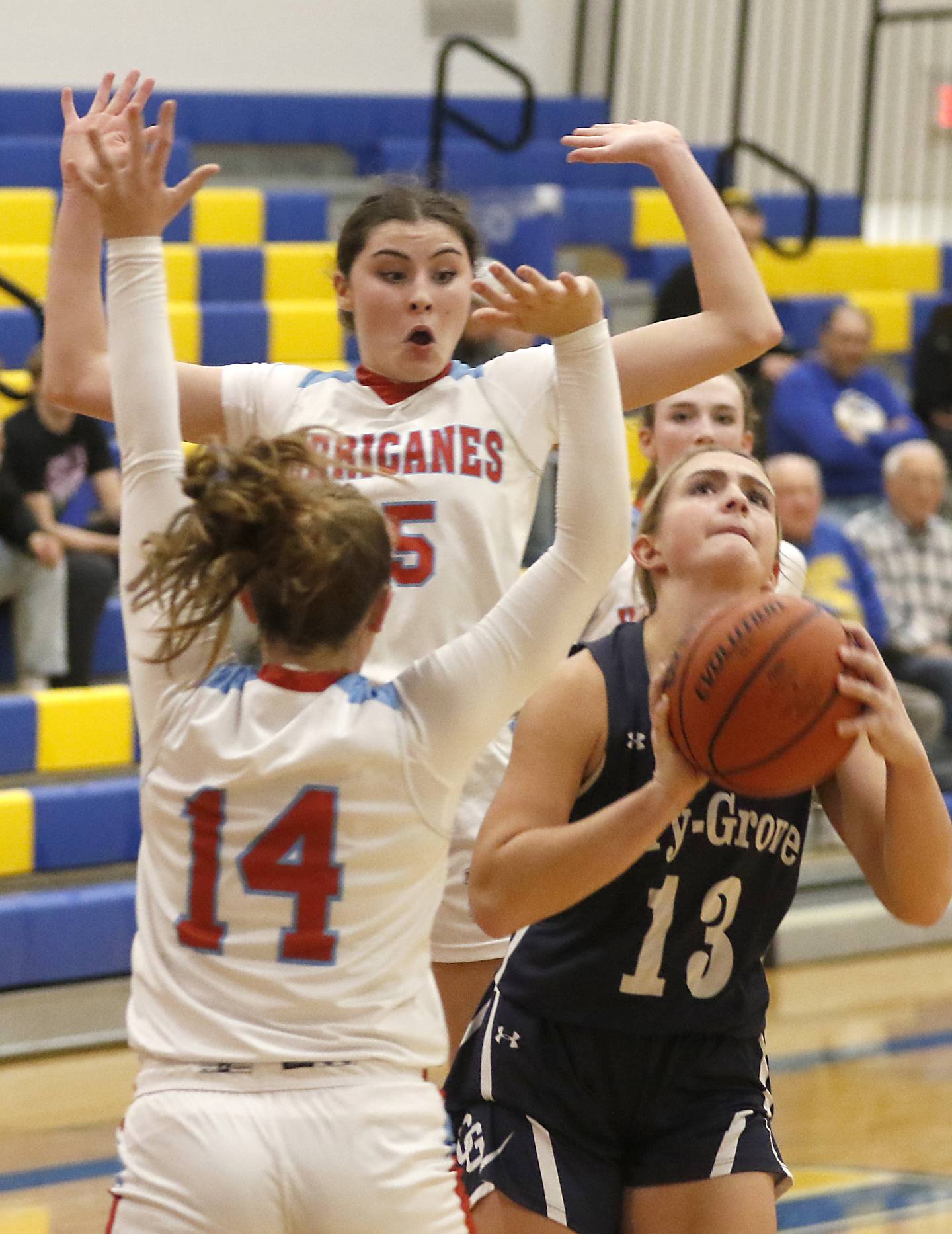 Marian Central's Kiara Kelly reacts as Cary-Grove's Malaina Kurth splits the defense of Kelly and Marian Central's Abbey Miner on Thursday, Nov. 16, 2023, during Johnsburg Thanksgiving Tournament girls basketball game  at Johnsburg High School.