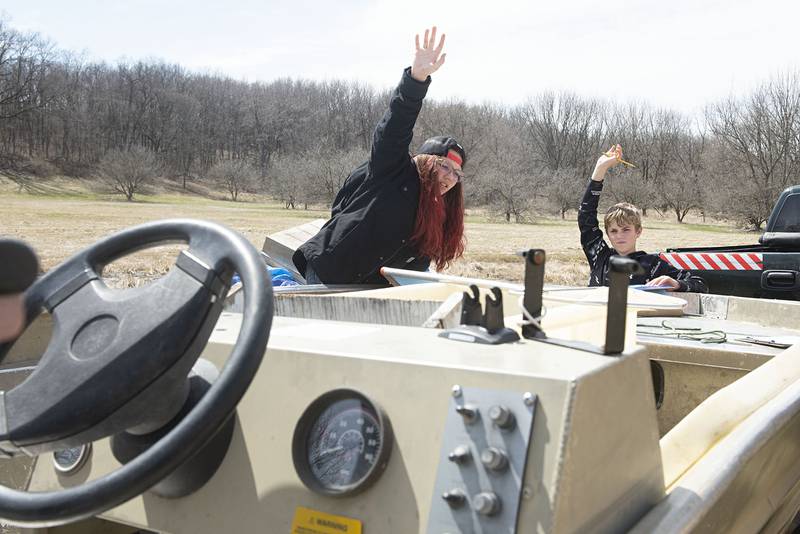 Evelyn Mann and Parker Simons raise their hands for questions while learning about the hatchery.