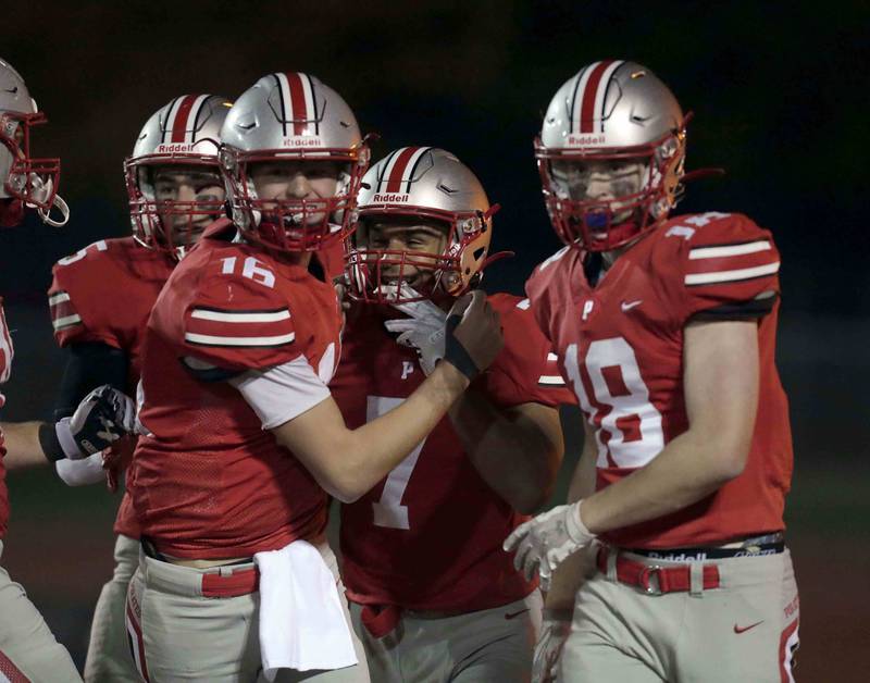 Palatine's Dominik Ball (7) celebrates his second touchdown with teammates Tommy Elter (16) Ryan Donnelly (18) and Thomas Coroneos (5)  Friday October 21, 2022 in Palatine.