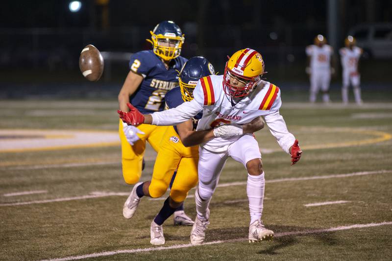 Sterling’s Mateo Vasquez hits Rock Island’s Amare Overton Friday, Oct.7, 2022.