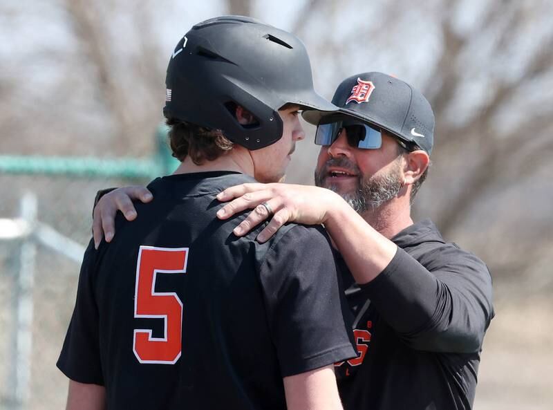 DeKalb head coach Josh Latimer gives some encouragement to Cole Latimer during their game against Kaneland Saturday, April 12, 2025, at Kaneland High School in Maple Park.
