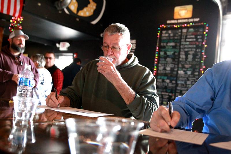 Dan Young of Batavia tastes water in a blind taste test on Thursday, Dec. 19, 2024 during the annual Kane County Water Association's annual water tasting contest at Global Brew in St. Charles.