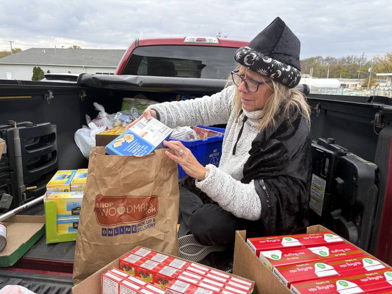 Tammy Gould organizes donations from the Villas at Bull Valley Halloween food drive Oct. 31, 2025.