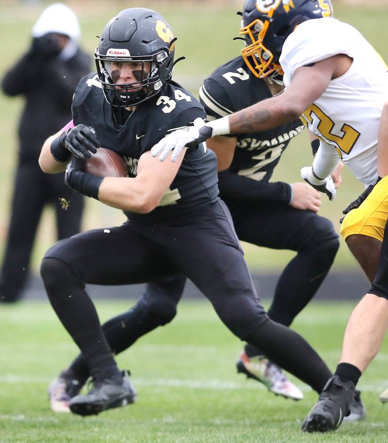 Sycamore's Joey Puleo tries to avoid Sterling's Christian Beasley during their Class 5A state playoff game Saturday, Nov. 12, 2022, at Sycamore High School.