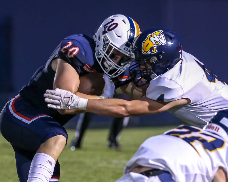 Oswego's Dylan King (20) is tackled by Neuqua Valley's Luke Brosnan (4) during a football game between Neuqua Valley and Oswego on Friday, Aug. 30, 2024 in Oswego. Gary E Duncan Sr for Shaw Local News Network.