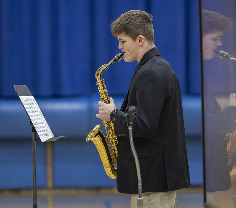 Newman sophomore Ayden Gutierrez plays “Careless Whisper” on the saxophone Thursday, Jan. 30, 2025, during a talent show at the high school. NHS held the show in celebration of Catholic Schools Week.