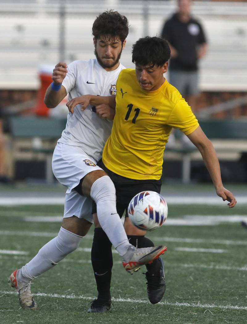 Wauconda's Sam Jurczyk kicks the ball away from Harvard's Diego Ramirez during the IHSA Boys Soccer 2A Grayslake Central Sectional semifinal match on Tuesday, Oct. 29, 2024, at Grayslake Central High School,