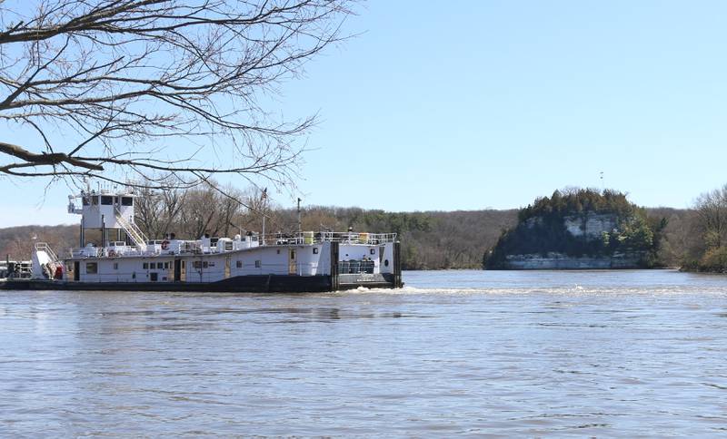 A barge waits to lock through the Starved Rock Lock & Dam on Tuesday, April 9, 2024 in front of the iconic Starved Rock State Park landmark. IDNR issued a statement acknowledging that park names could be reconsidered, including Starved Rock.