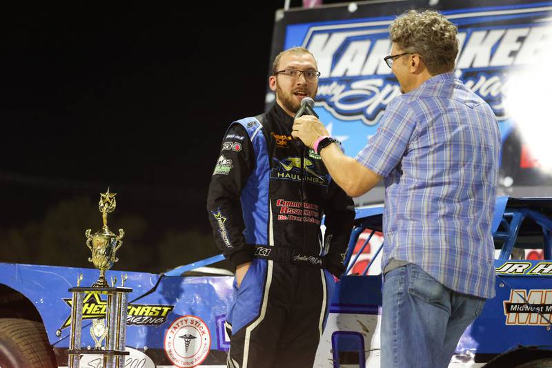 Austin McCarty, left, interviews with announce Bill Yohnka as he is awarded the Pro Late Model class champion trophy on Friday, Sept. 26, 2025, at the Kankakee County Speedway. McCarty won the title for the second year in a row, earning the McCarty family's 10th overall title.