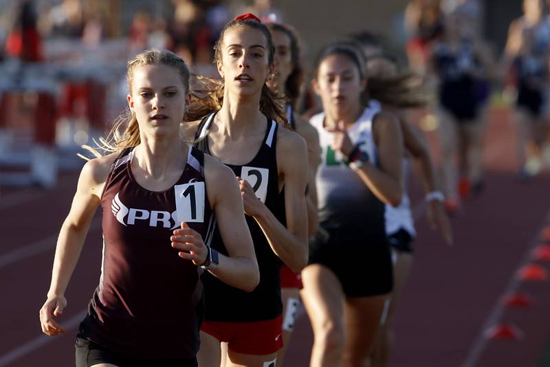 Prairie Ridge's Rachel Soukup leads the pack on her way to winning the 3200 meter relay Friday, May 10, 2023, during the IHSA Class 3A Huntley Girls Track and Field Sectional at Huntley High School.