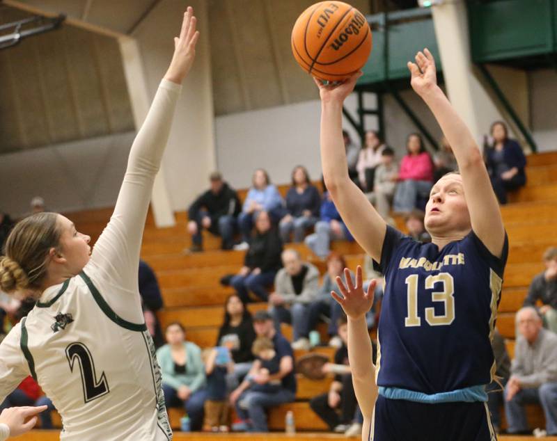 Marquette's Emily Ryan-Adair lets go of a shot over Midland's Jordyn Pyles on Thursday, Feb. 12, 2026 at Midland High School.