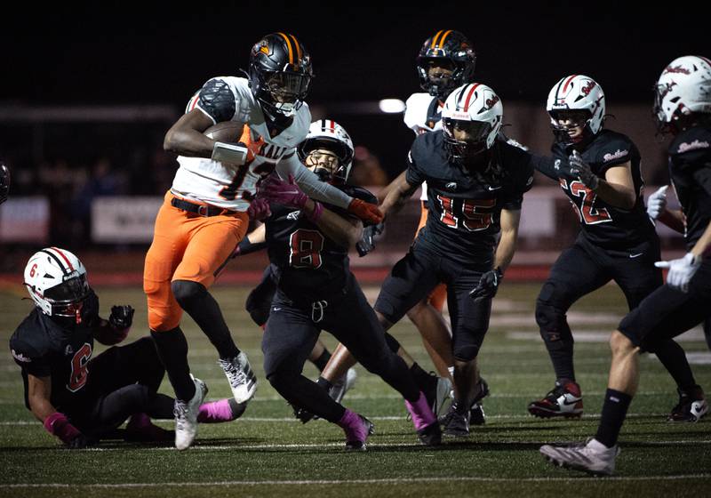 Dekalb's Davon Grant carries the ball on a play as a pack of Bradley-Bourbonnais players try to bring him down in a game on Friday, October 10, 2025.