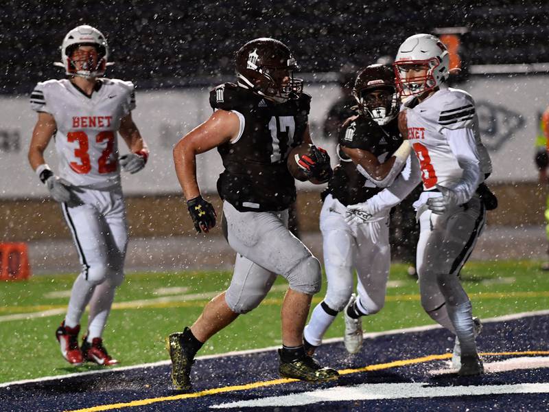 Joliet Catholic's Hunter Powell runs in a touchdown during a game against Benet Friday Oct. 14, 2022 at Joliet Memorial Stadium