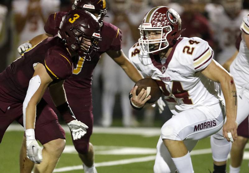 Morris’ Ashton Yard looks for running room as he is chased by Richmond-Burton's Zach Smith, left, during a Kishwaukee River Conference / Interstate 8 Conference crossover football game Friday, Sept. 30, 2022, between Richmond-Burton and Morris at Richmond-Burton Community High School in Richmond.