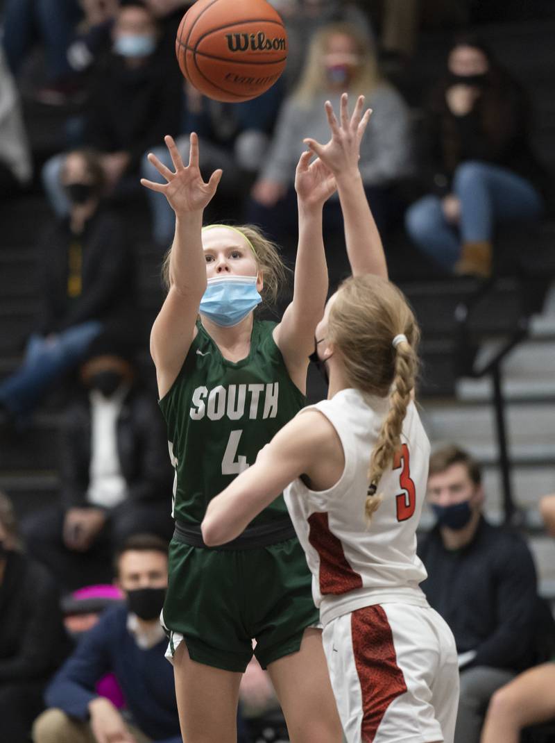 Crystal Lake South's Addison Alexander takes a shot over McHenry's Peyton Stinger during their game on Tuesday, January 11, 2022 in McHenry.