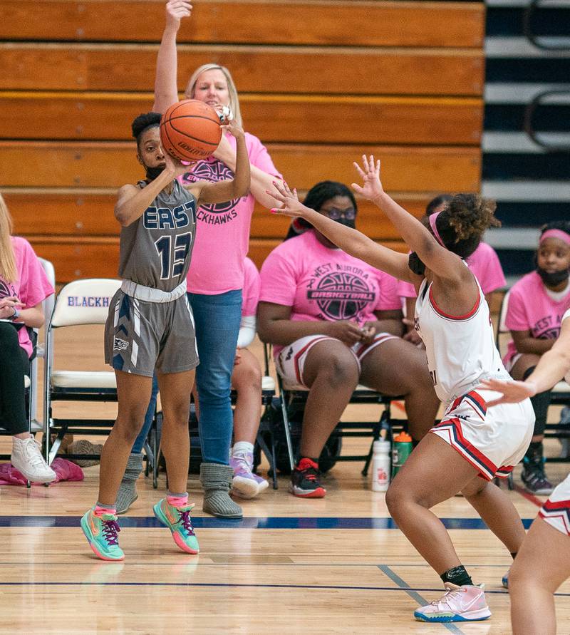 Oswego East's Cydnei Mitchell (13) shoots a three pointer against West Aurora during a basketball game at West Aurora High School on Wednesday, Jan 26, 2022.