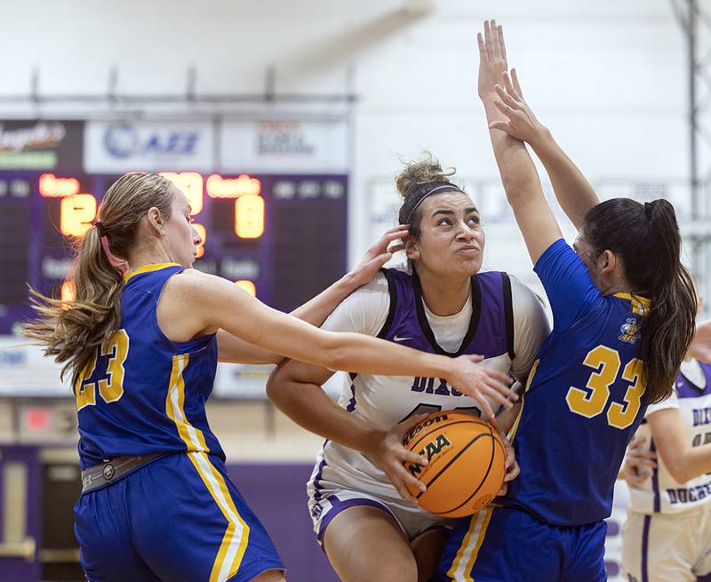 Dixon's Hallie Williamson works in the paint against Aurora Central’s Riley Cwinski (left) and Sofia Corral Thursday, Dec. 26, 2024, during the Dixon Girl’s KSB Holiday Basketball Classic.