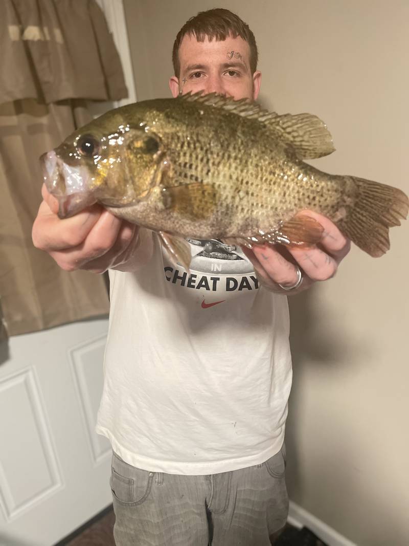 Crystal Lake's Jacob Caso holds his record-breaking rock bass.