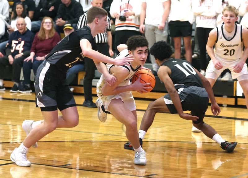 Sycamore's Marcus Johnson splits two Kaneland defenders during their game Friday, Jan. 9, 2025, at Sycamore High School.