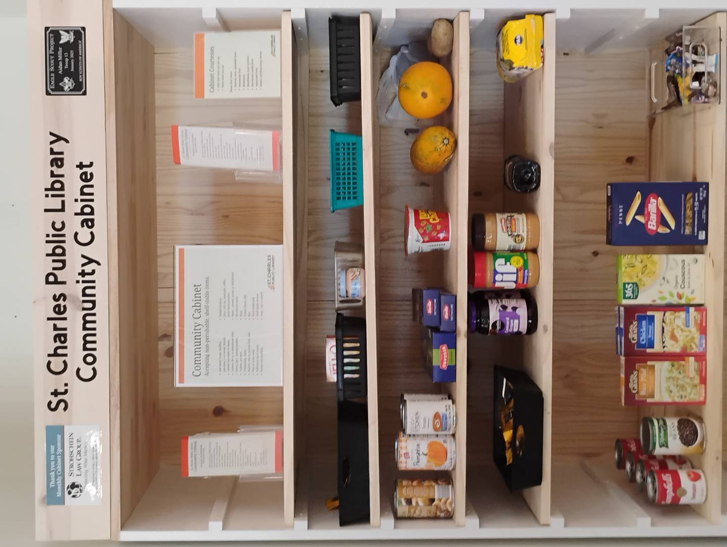 The St. Charles Public Library Community Cabinet, created as an Eagle Scout project by Aidan Miller of Troop 13, which was installed in February. Food is available to anyone while the library is open.