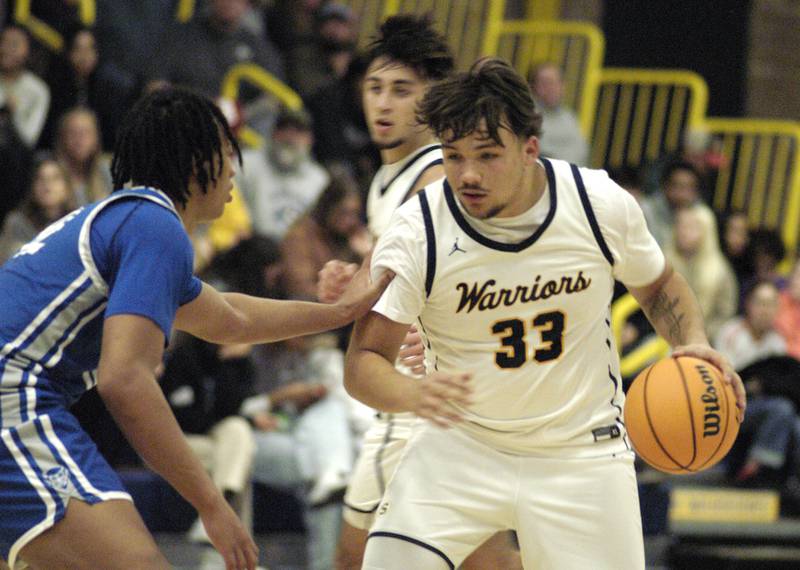 Sterling's  Maddux  Osborn handles the ball against a Quincy defender. The action took place on Friday, December 13th at Sterling.