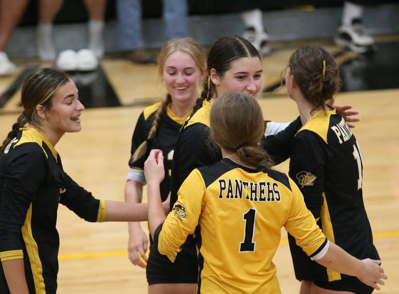 Members of the Putnam County volleyball team smile after getting a point against Marquette on Thursday, Sept 7, 2023 at Putnam County High School.