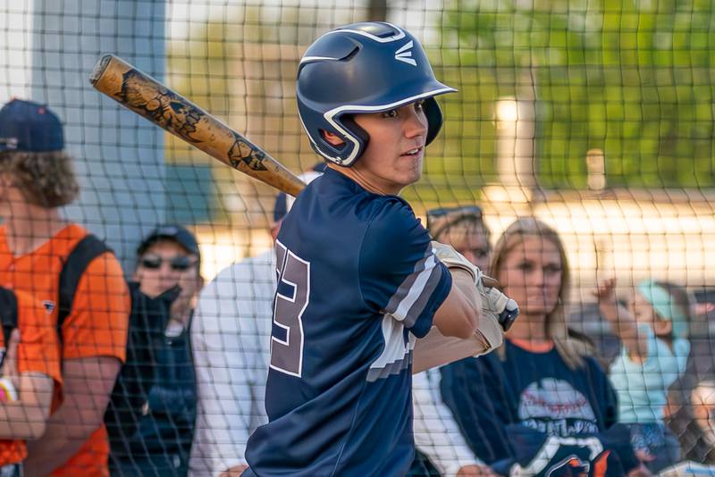 Oswego East's Mason Blanco (23) singles driving in a run against Oswego during a baseball game at Oswego High School on Tuesday, May 9, 2023.