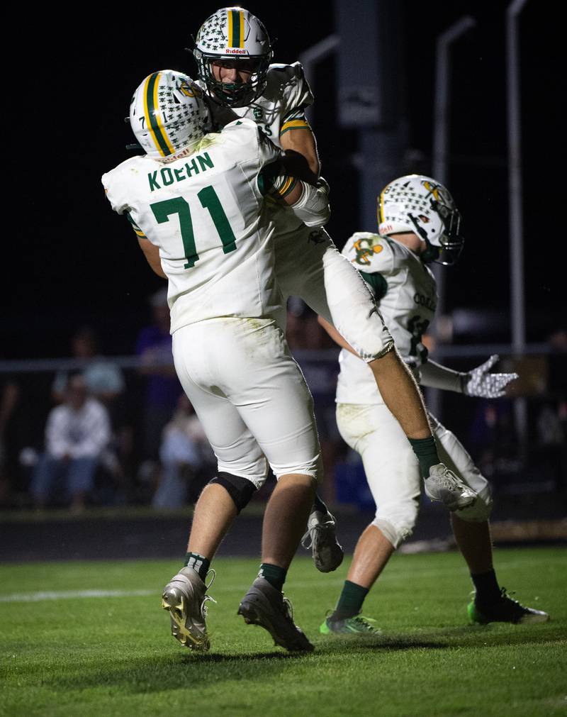 Coal City's Gaven Vestal, center, celebrates his touchdown with Wyatt Koehn in a game against Manteno on Friday, October 3, 2025.