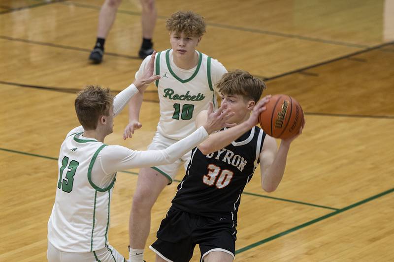 Byron’s Jacob Lawver is guarded by Rock Falls’ Aydan Goff (left) and Kuitim Heald Friday, Jan. 6, 2023.