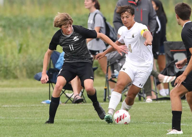 Kaneland's Matthew Mitchinson (left) and Sycamore's Ethan Royer fight for possession during their game Wednesday, Sept. 6, 2023, at Kaneland High School in Maple Park.