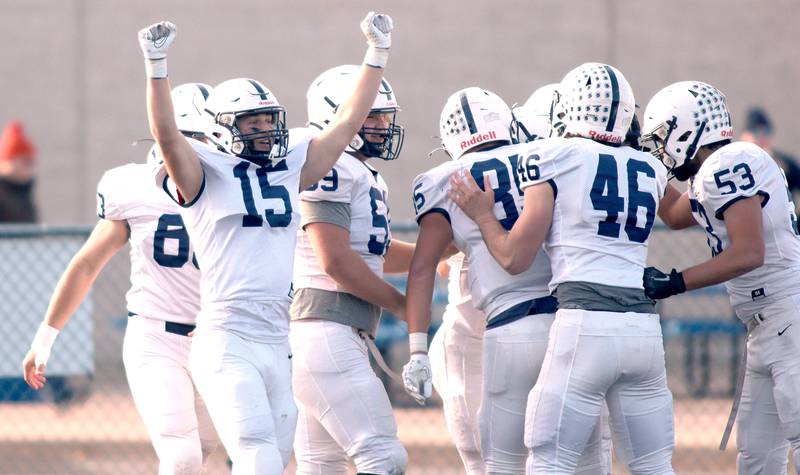 Cary-Grove’s Jake Hornok (15) and the Trojans celebrate a Holden Boone touchdown against Highland Park in second-round IHSA Class 6A playoff action at Wolters Field in Highland Park Saturday.