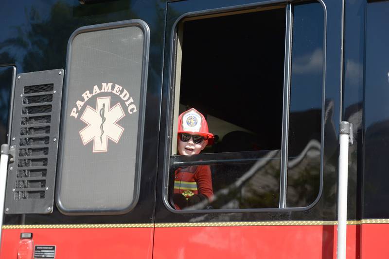 Charles Klinker of Downers Grove peaks his head out of a fire truck during the Kids Muster with the DG Fire Department event held Saturday August 23, 2025.