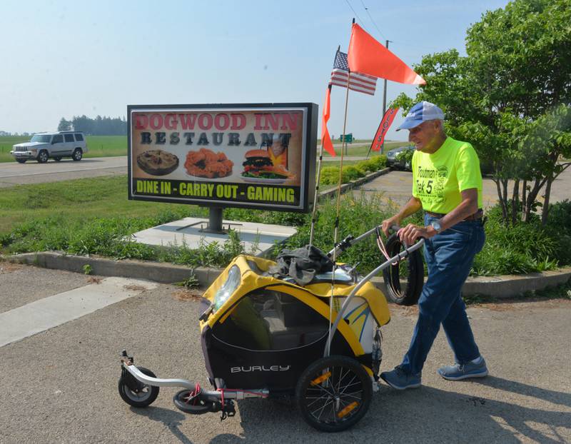 Dean Troutman pushes his cart as he heads to Forreston after enjoying breakfast at the Dogwood Inn, along Illinois 26, between Forreston and Polo. Troutman, 92, of Princeville, Illinois, is walking to raise money for St. Jude's. He spent Saturday night at the Polo Ambulance Office and will spend Sunday night at the Forreston Fire Station before heading north to Freeport.
