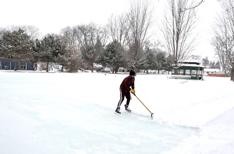 Sugar Grove Park District employee David Del Giudice clears snow from the ice rink on Friday, Jan. 10, 2025 behind the Sugar Grove Township Community Building. The rink, which is possible through a partnership between the Sugar Grove Park District, Sugar Grove Township Sugar Grove Fire Protection District and Village of Sugar Grove,  is frozen and ready for skaters.