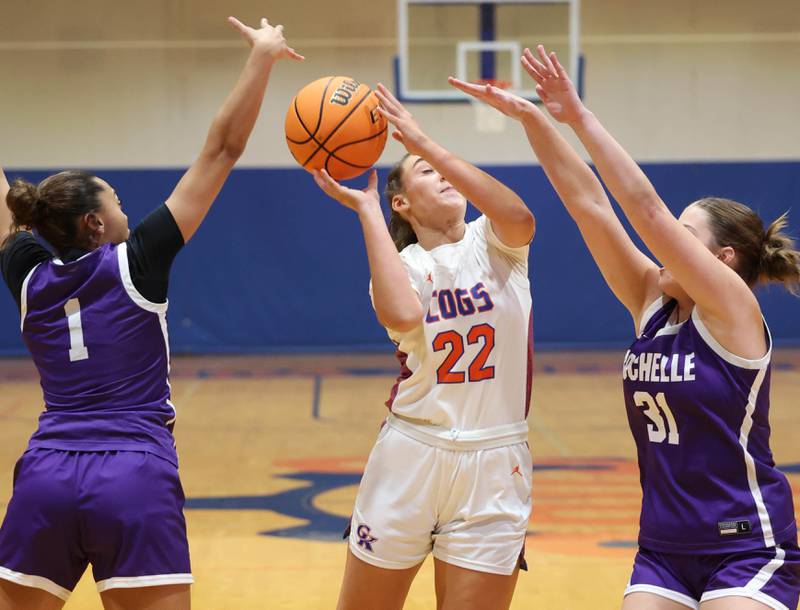 Genoa-Kingston's Regan Creadon goes to the basket between two Rochelle defenders during their game Monday, Dec. 16, 2024, at Genoa-Kingston High School.