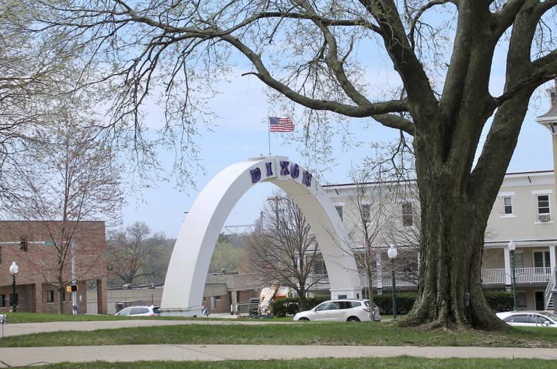 Clear skies mark a spring day as trees show buds at the Old Lee County Courthouse campus with the Dixon Galena Avenue arch in the background on Friday, April 14, 2023.