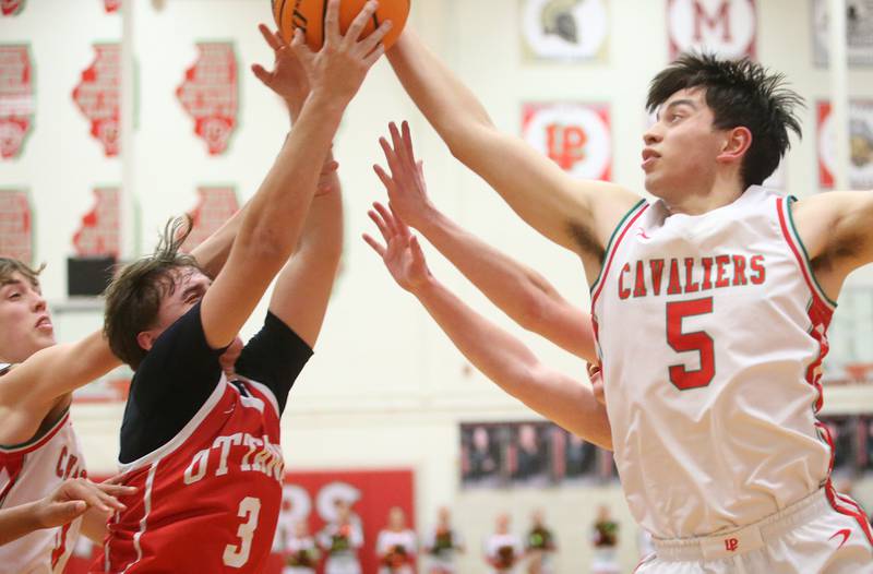 L-P's Erick Sotelo grabs a rebound over Ottawa's Connor Diederich on Friday, Feb. 7, 2025 in Sellett Gymnasium at L-P High School.